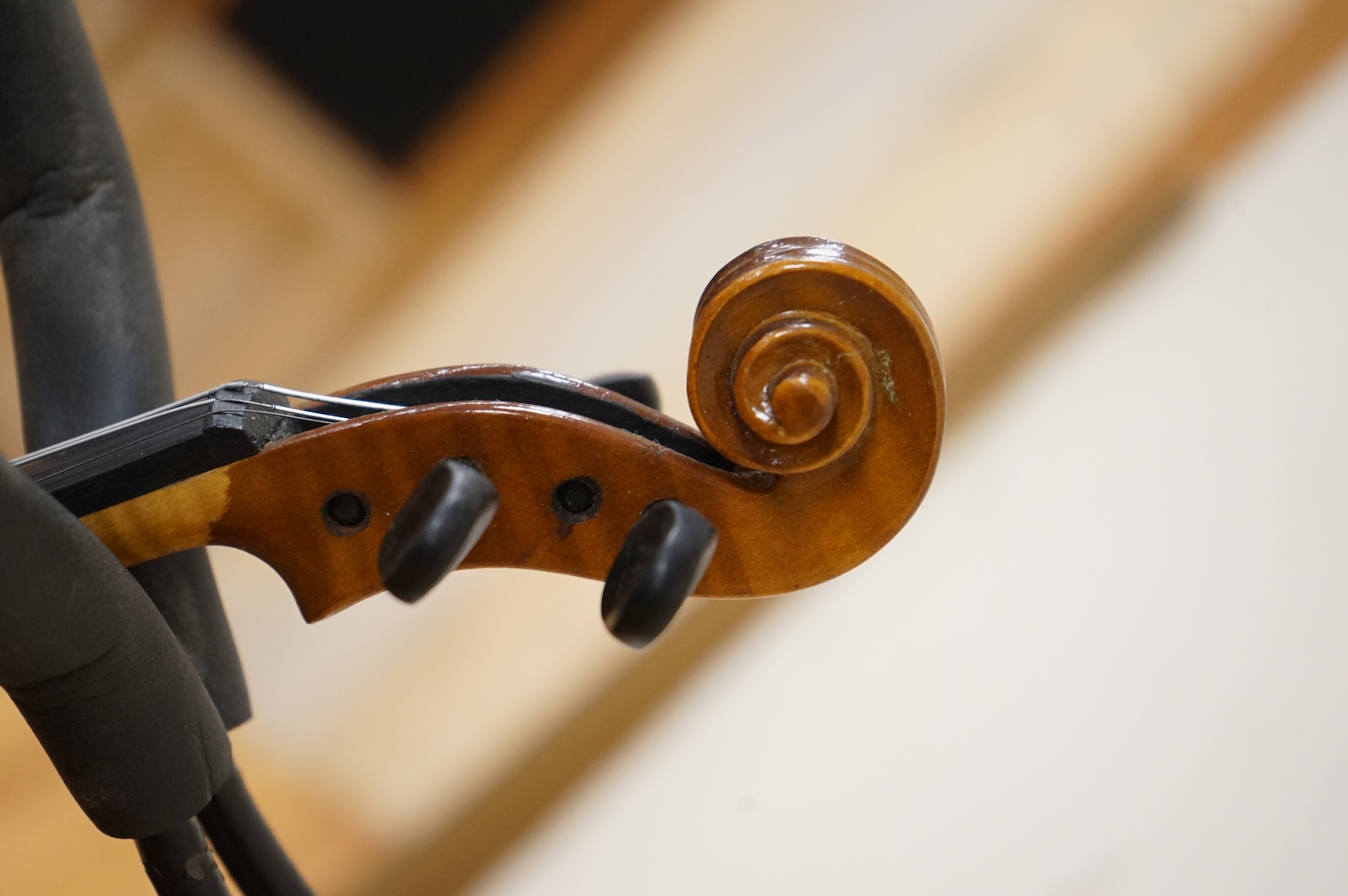 Five cased 20th century violins, including; a German violin, two Czech violins, a three-quarter size violin with a label for Bienfait, and a Romanian quarter size violin, all in cases or the remains of cases.